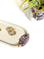 Amethyst Concrete Jewelry Tray pictured with a large Raw Amethyst Air Plant Planter. Our concrete crystal planters would be the perfect gift or addition to your office. We offer these planters in a variety of other concrete shapes and crystals. 